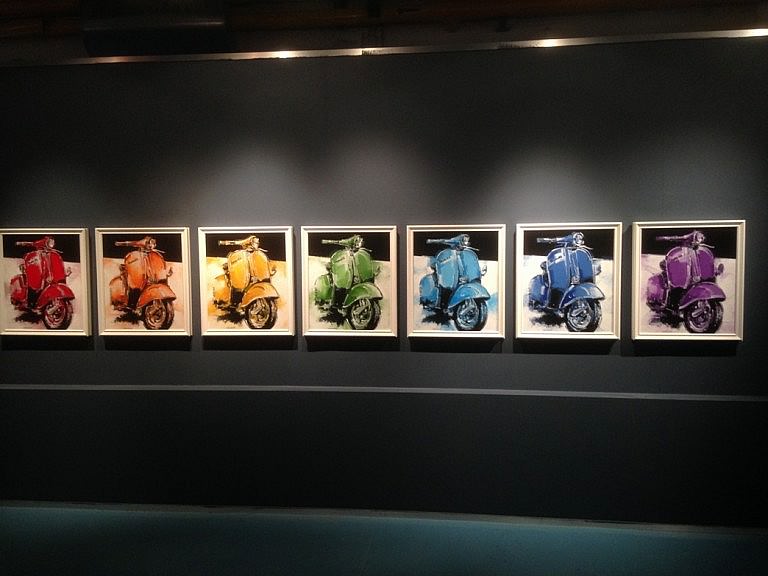 A temporary exhibition of paintings at the Vespa museum