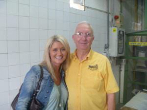 A smiling honeymooner next to Dino the pasta maker