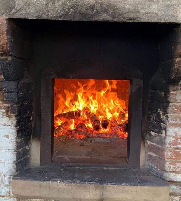 Baking pizza in the wood burning oven