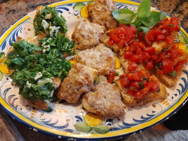 Bruschetta al pomodoro, crostino salsiccia e stracchino, bruschetta con rucola salda and parmesan cheese