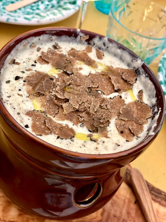 Black truffle shaved in the cheese fondue