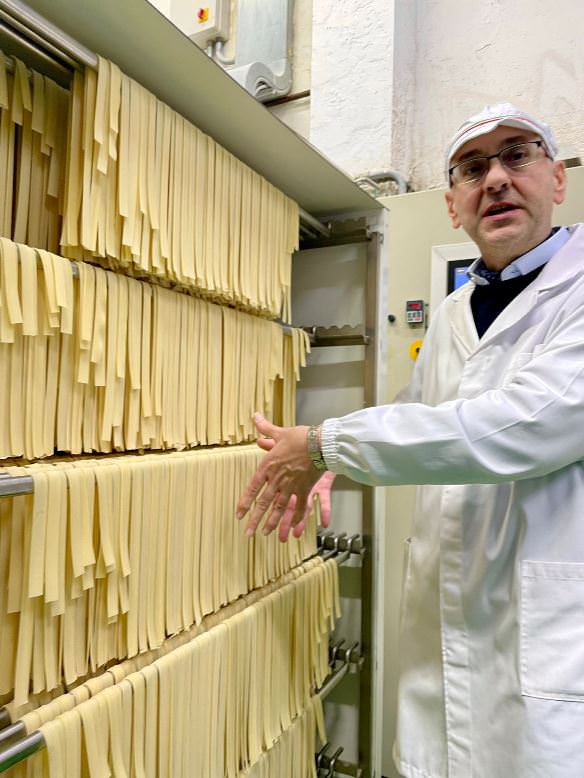 The owner of the company showing his famous pasta